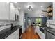 Bright kitchen with stainless appliances, dark countertops and view to living room at 2295 Rio Cir, Spring Hill, FL 34608