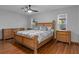 Primary bedroom features a wooden bed frame and natural light from the windows at 2295 Rio Cir, Spring Hill, FL 34608