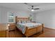 Primary bedroom features a wooden bed frame and natural light from the windows at 2295 Rio Cir, Spring Hill, FL 34608