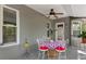 Charming covered patio featuring a table, chairs, and ceiling fan, great for outdoor entertainment at 2295 Rio Cir, Spring Hill, FL 34608