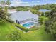 Aerial view of the house featuring a pool and a large, well-maintained backyard at 2519 Shipston Ave, New Port Richey, FL 34655
