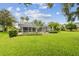 Lush backyard featuring well-maintained lawn and landscaping with a screened-in lanai at 2519 Shipston Ave, New Port Richey, FL 34655