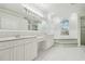 Bright bathroom with a double vanity, garden tub, and separate shower at 2519 Shipston Ave, New Port Richey, FL 34655