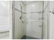 Tiled shower with glass door and decorative trim at 2519 Shipston Ave, New Port Richey, FL 34655