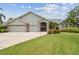 Charming single-story home featuring a three-car garage and well-manicured landscaping at 2519 Shipston Ave, New Port Richey, FL 34655