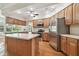 Modern kitchen boasts stainless steel appliances, a center island, and ample cabinet space at 2519 Shipston Ave, New Port Richey, FL 34655
