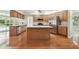 Well-equipped kitchen with an island, stainless steel appliances, and wood cabinets at 2519 Shipston Ave, New Port Richey, FL 34655