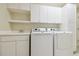 Well-organized laundry room with built-in cabinets, sink, and modern washer and dryer at 2519 Shipston Ave, New Port Richey, FL 34655