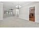 Open-concept living area with a view of the front entrance and adjacent kitchen at 2519 Shipston Ave, New Port Richey, FL 34655