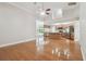 Open-concept living room featuring hardwood floors, high ceilings, and a view of the modern kitchen at 2519 Shipston Ave, New Port Richey, FL 34655