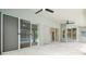 Covered patio featuring ceiling fans and multiple sliding glass doors overlooking the pool area at 2519 Shipston Ave, New Port Richey, FL 34655