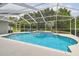 Inviting screened-in pool area with a built-in spa and ample deck space for outdoor lounging at 2519 Shipston Ave, New Port Richey, FL 34655