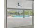 View from inside looking out at the screened-in pool and spa, perfect for indoor/outdoor living at 2519 Shipston Ave, New Port Richey, FL 34655