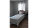 Bedroom with decorative curtains, wood floors, and soft natural light from the window at 2870 26Th N Ave, St Petersburg, FL 33713