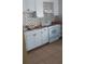 Cozy kitchen with white cabinets, light countertops, and sleek appliances on a ceramic tile floor at 2870 26Th N Ave, St Petersburg, FL 33713