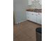 Compact kitchen area featuring light wood countertops, a double basin sink, and white cabinets at 2870 26Th N Ave, St Petersburg, FL 33713