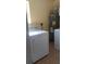 Laundry room featuring a washing machine, dryer, and water heater with tile floors at 2870 26Th N Ave, St Petersburg, FL 33713