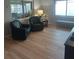 Inviting living room featuring wood floors, matching armchairs, and a decorative bench by the bright window at 2870 26Th N Ave, St Petersburg, FL 33713