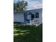 A pleasant backyard patio features an umbrella-shaded table and chairs perfect for outdoor relaxation and entertaining at 2870 26Th N Ave, St Petersburg, FL 33713