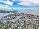 Stunning aerial view showcasing the waterfront community with canals, homes, and access to the beach at 336 Boca Ciega Dr, Madeira Beach, FL 33708