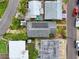 Aerial shot of a house's roof and lot, with solar panels visible, surrounded by neighboring properties in a residential area at 336 Boca Ciega Dr, Madeira Beach, FL 33708