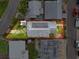 Aerial shot of a house's roof and lot, with solar panels visible, surrounded by neighboring properties in a residential area at 336 Boca Ciega Dr, Madeira Beach, FL 33708