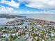 Aerial view showcasing the waterfront community with canal access and proximity to the sandy beach at 336 Boca Ciega Dr, Madeira Beach, FL 33708