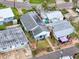 Aerial view of a home featuring solar panels, nestled among other homes in a waterfront community at 336 Boca Ciega Dr, Madeira Beach, FL 33708