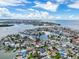 Aerial view showing the location of a waterfront home near canals and a sandy beach at 336 Boca Ciega Dr, Madeira Beach, FL 33708