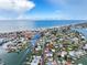 Coastal neighborhood with a waterway, palm trees, charming homes, and easy access to the beach at 336 Boca Ciega Dr, Madeira Beach, FL 33708