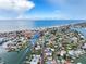 Breathtaking aerial view of waterfront homes, a canal, and the beach under a bright blue sky at 336 Boca Ciega Dr, Madeira Beach, FL 33708