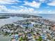 Panoramic aerial showing proximity to waterfront canals, a vibrant neighborhood, and the nearby beach at 336 Boca Ciega Dr, Madeira Beach, FL 33708