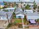 Aerial view of a solar-paneled home within a vibrant residential neighborhood at 336 Boca Ciega Dr, Madeira Beach, FL 33708