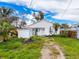 Backyard featuring an open lot, gravel driveway, storage shed, and small tropical trees at 336 Boca Ciega Dr, Madeira Beach, FL 33708