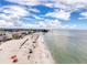 Beach aerial showing tourists enjoying the sunny day near a shoreline with city views and a bright blue sky at 336 Boca Ciega Dr, Madeira Beach, FL 33708