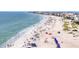 Expansive beach view with clear turquoise water, beachgoers, and a picturesque cityscape skyline in the background at 336 Boca Ciega Dr, Madeira Beach, FL 33708