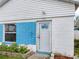 Side view of home with blue brick and white walls at 336 Boca Ciega Dr, Madeira Beach, FL 33708