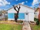 Charming cottage-style home with a unique blue accent wall and well-maintained front yard at 336 Boca Ciega Dr, Madeira Beach, FL 33708
