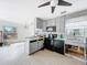 Kitchen with grey cabinets, granite countertops, and black appliances at 336 Boca Ciega Dr, Madeira Beach, FL 33708