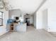 Open kitchen and living room with gray cabinetry and black appliances at 336 Boca Ciega Dr, Madeira Beach, FL 33708