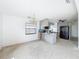 Open kitchen to the living room, featuring gray cabinets and black appliances at 336 Boca Ciega Dr, Madeira Beach, FL 33708