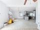 Open concept living room and kitchen with a ceiling fan and gray cabinets at 336 Boca Ciega Dr, Madeira Beach, FL 33708