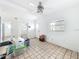 View of a bright living room with ceramic tile and a ceiling fan at 336 Boca Ciega Dr, Madeira Beach, FL 33708