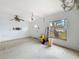 Bright living room featuring a window, ceiling fan, and white front door at 336 Boca Ciega Dr, Madeira Beach, FL 33708