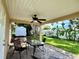 Relaxing back patio with a table, chairs, and a view of the well-maintained backyard at 3447 Paloma Dr, Holiday, FL 34690