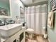 Bright bathroom featuring a modern vanity with sink and a tub/shower combination with stylish tiling at 3447 Paloma Dr, Holiday, FL 34690