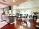 Dining area featuring a modern table set, gleaming hardwood floors, and large windows at 3447 Paloma Dr, Holiday, FL 34690