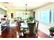 Dining area with hardwood floors, chandelier, large window, and barstool seating at the kitchen counter at 3447 Paloma Dr, Holiday, FL 34690
