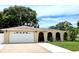 Charming home with a well-manicured lawn, inviting arched entryway, and a two-car garage at 3447 Paloma Dr, Holiday, FL 34690