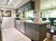 Modern kitchen with sleek cabinetry, stainless steel appliances, and a view into the dining area at 3447 Paloma Dr, Holiday, FL 34690